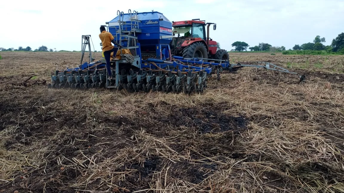 A tractor-drawn planter sowing a field during Season B at Normah's farm.